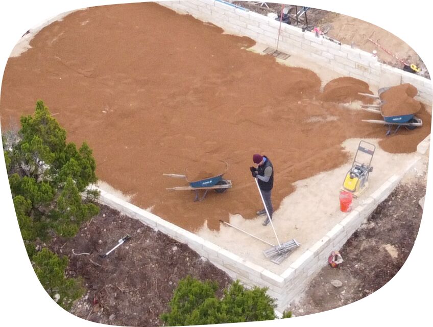 Synthetic grass installation process of land preparation and base setup.