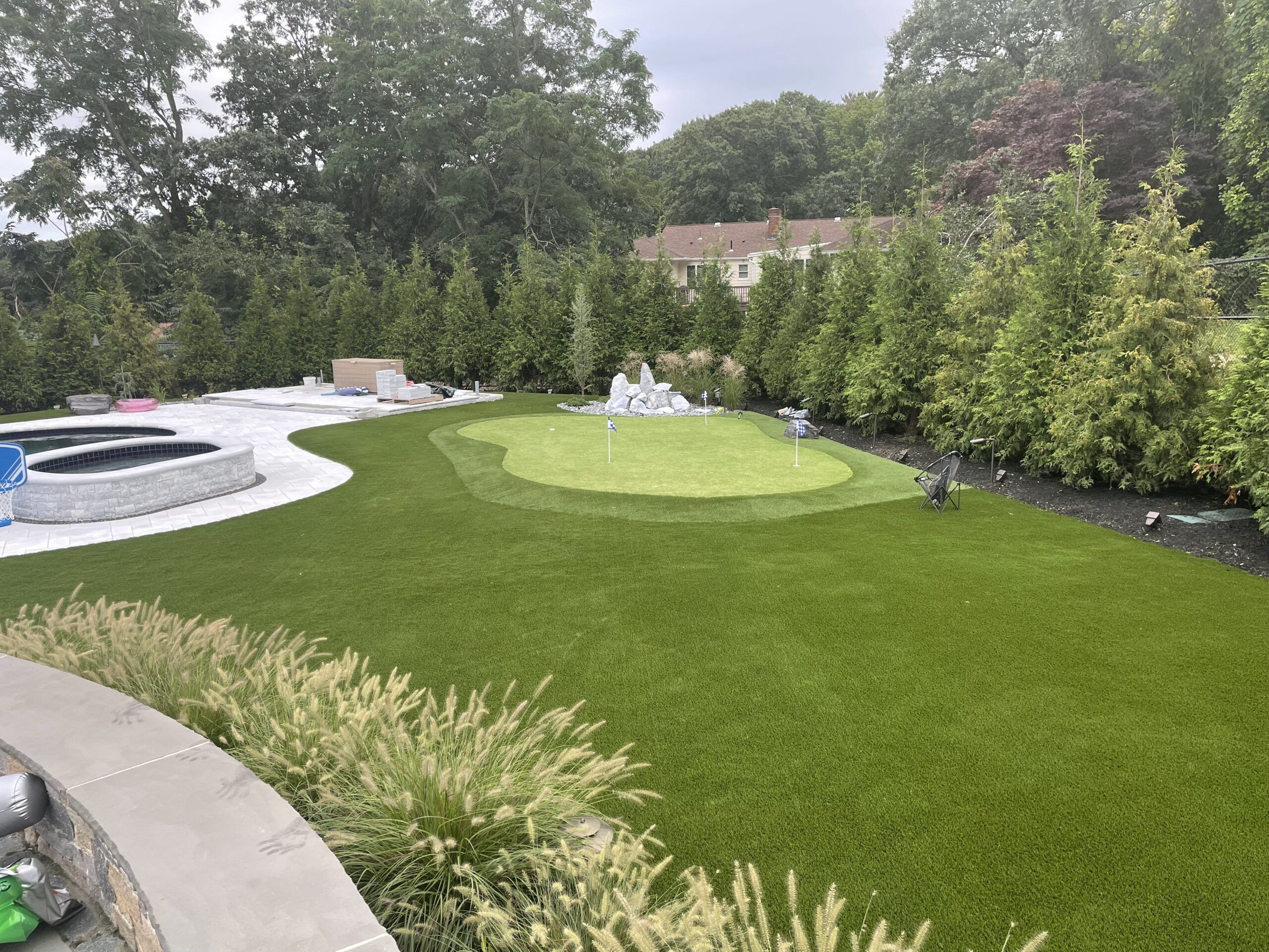 backyard putting green artificail turf around pool boston